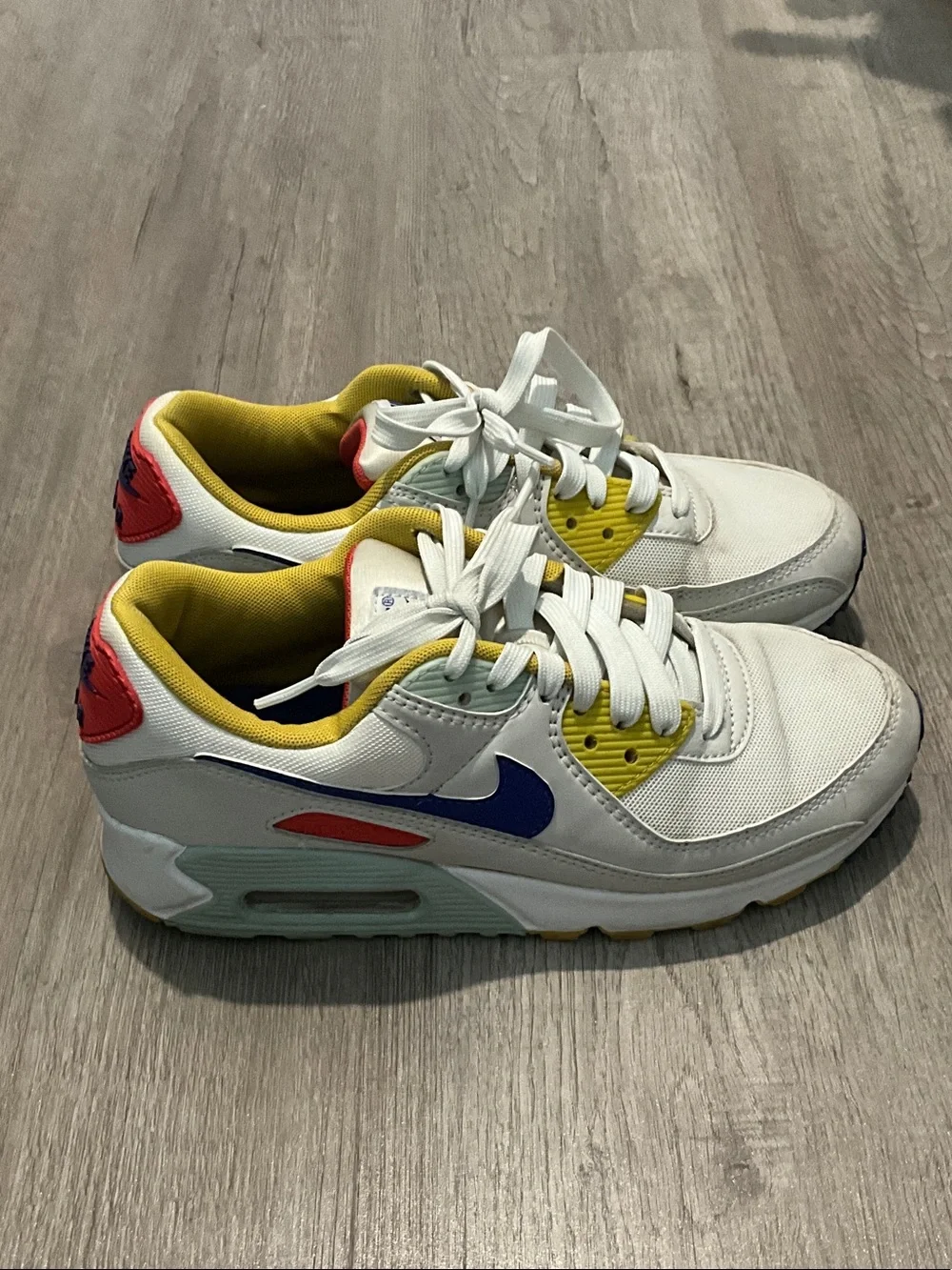Nike White Sneakers with Blue, Yellow and Red Accents